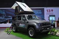 VISITORS check the BAIC B40e Trailmaster rEV on display with a rooftop tent at the MIAS 2026 booth.