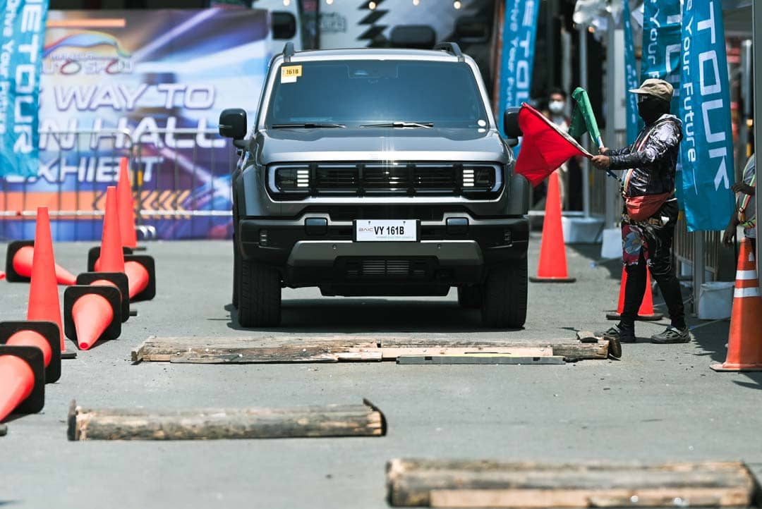 A MARSHAL guides the BAIC B40e Trailmaster rEV through an obstacle course during a test drive at MIAS 2026.
