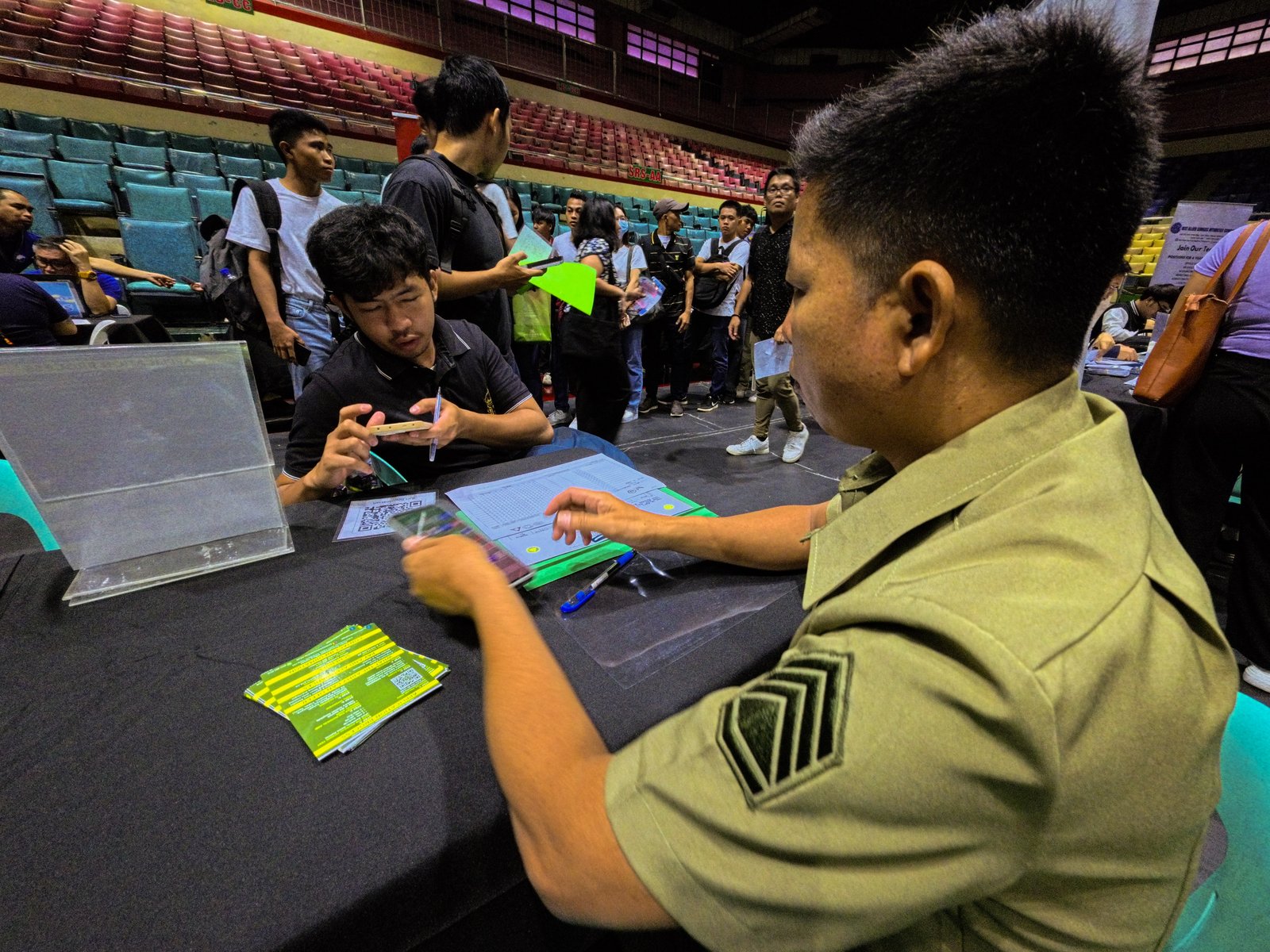 Staff Sergeant Ronnie Ado of the Army Recruitment Office, Philippine Army, facilitates applicants during a job fair at the Pasay City Astrodome today, 13 April 2026. Organized by the city government and its partner agencies, the event features 50 local and overseas employers offering over 6,000 job opportunities.