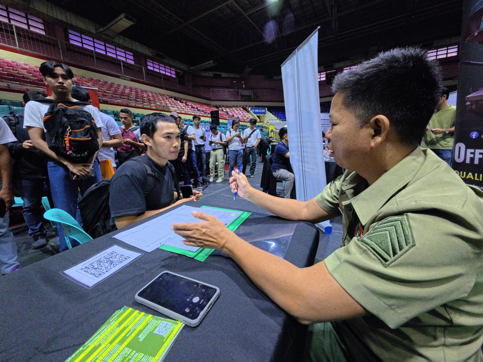 Staff Sergeant Ronnie Ado of the Army Recruitment Office, Philippine Army, facilitates applicants during a job fair at the Pasay City Astrodome today, 13 April 2026. Organized by the city government and its partner agencies, the event features 50 local and overseas employers offering over 6,000 job opportunities.