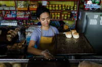 Bakers arrange trays of bread for sale at a bakery in Sta. Cruz, Manila, on Monday, 13 April 2026, as the city government is set to distribute a ₱25,000 subsidy to community bakeries to help offset higher input costs and maintain affordable bread for consumers.