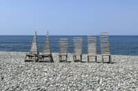 COMPLEMENTING the scenic pebbled beach view, unique wood art displays serve as the perfect backdrop throughout the property.