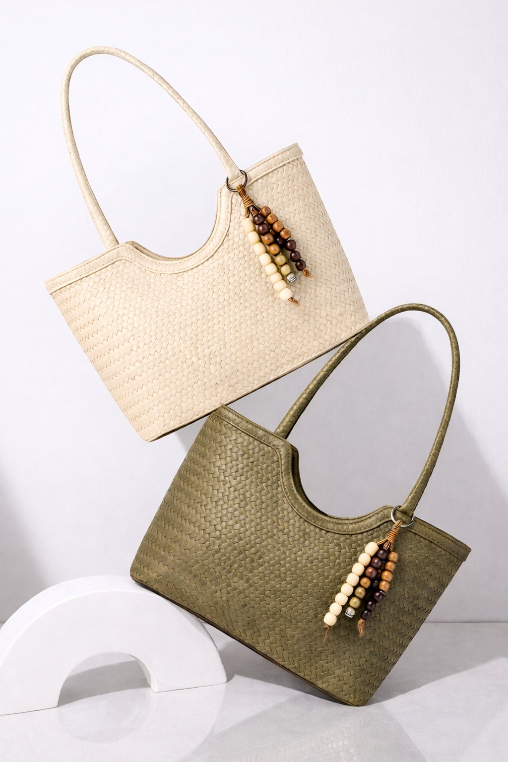 MAAN compact shoulder bag with a textured finish, slim strap and charm detail.