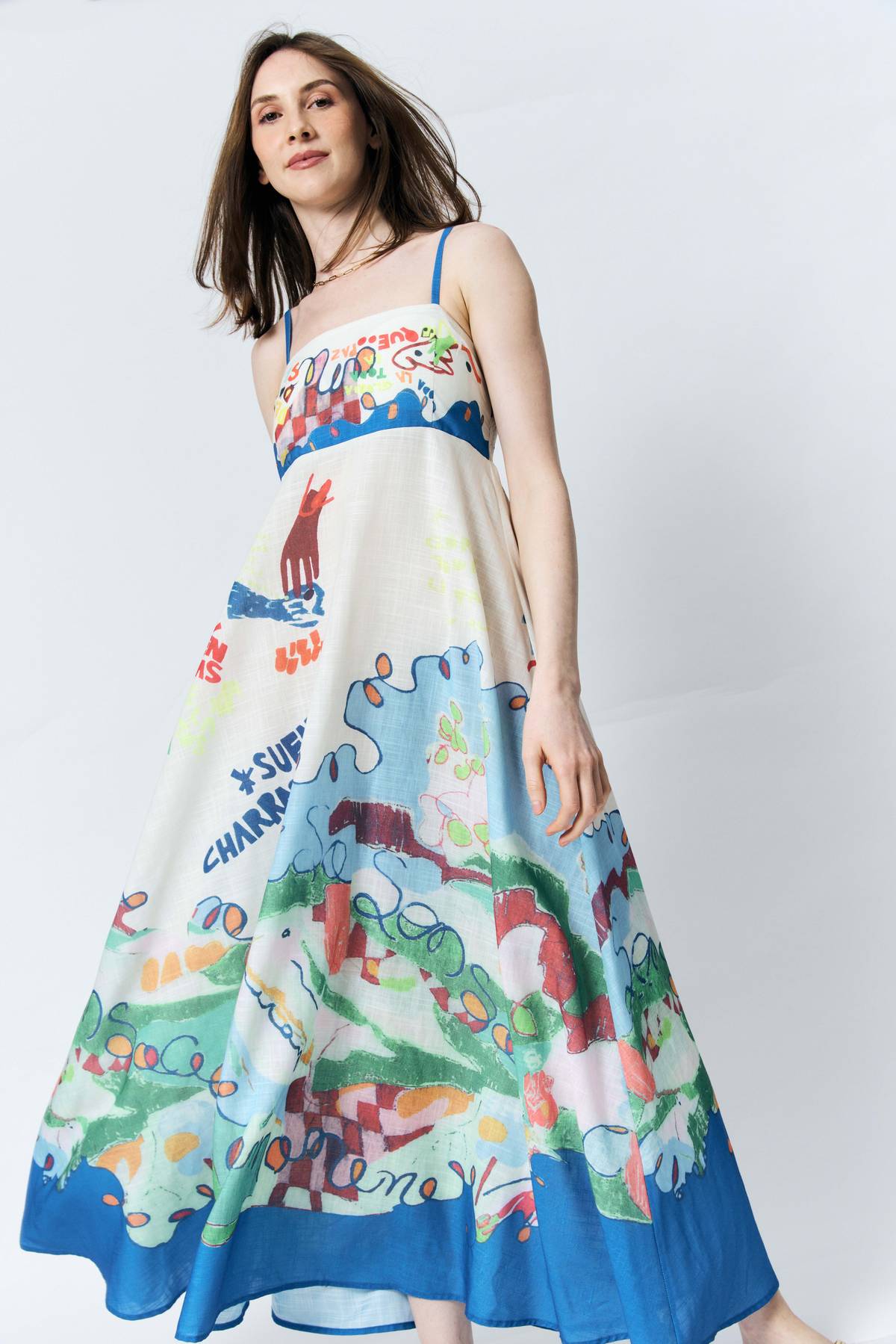 A SKETCHBOOK come to life This dress captures a sun-drenched Mediterranean spirit through a vibrant, hand-drawn collage of primary bolds and soft pastels. It’s coastal chic with a playful, illustrative soul.