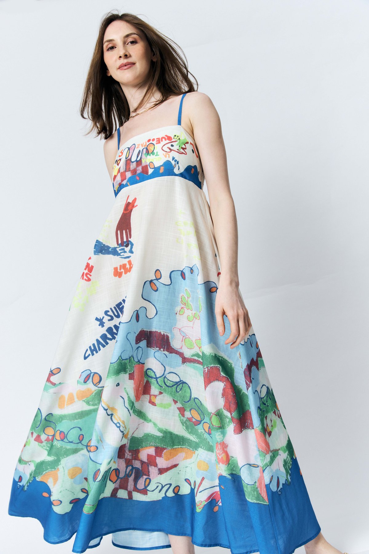A SKETCHBOOK come to life This dress captures a sun-drenched Mediterranean spirit through a vibrant, hand-drawn collage of primary bolds and soft pastels. It’s coastal chic with a playful, illustrative soul.