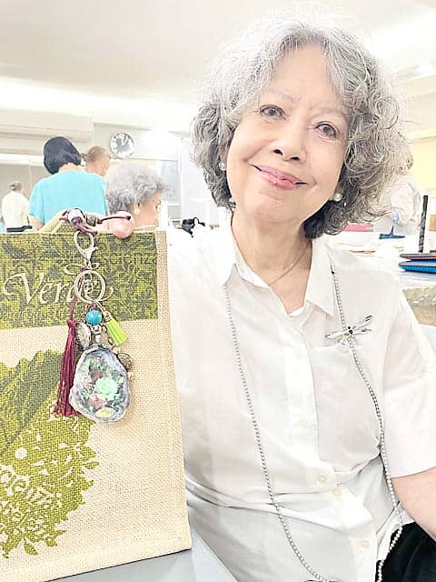 TESS Colayco shows a bag charm she made through Decoupage.