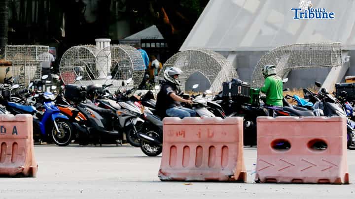 (April 17 2026) Motorcycles are parked at the entrance of the Quezon Memorial Circle in Quezon City as motorcycle taxi and delivery riders claim their P5,000 from Department of Social Welfare and Development (DSWD) personnel during a special payout schedule for unclaimed cash relief assistance on Friday April 17 2026. Photo/Analy Labor