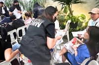 DEPARTMENT of Migrant Workers staffers process 138 overseas Filipino workers and 59 dependents who returned safely to the country from the United Arab Emirates and Qatar on Friday night.