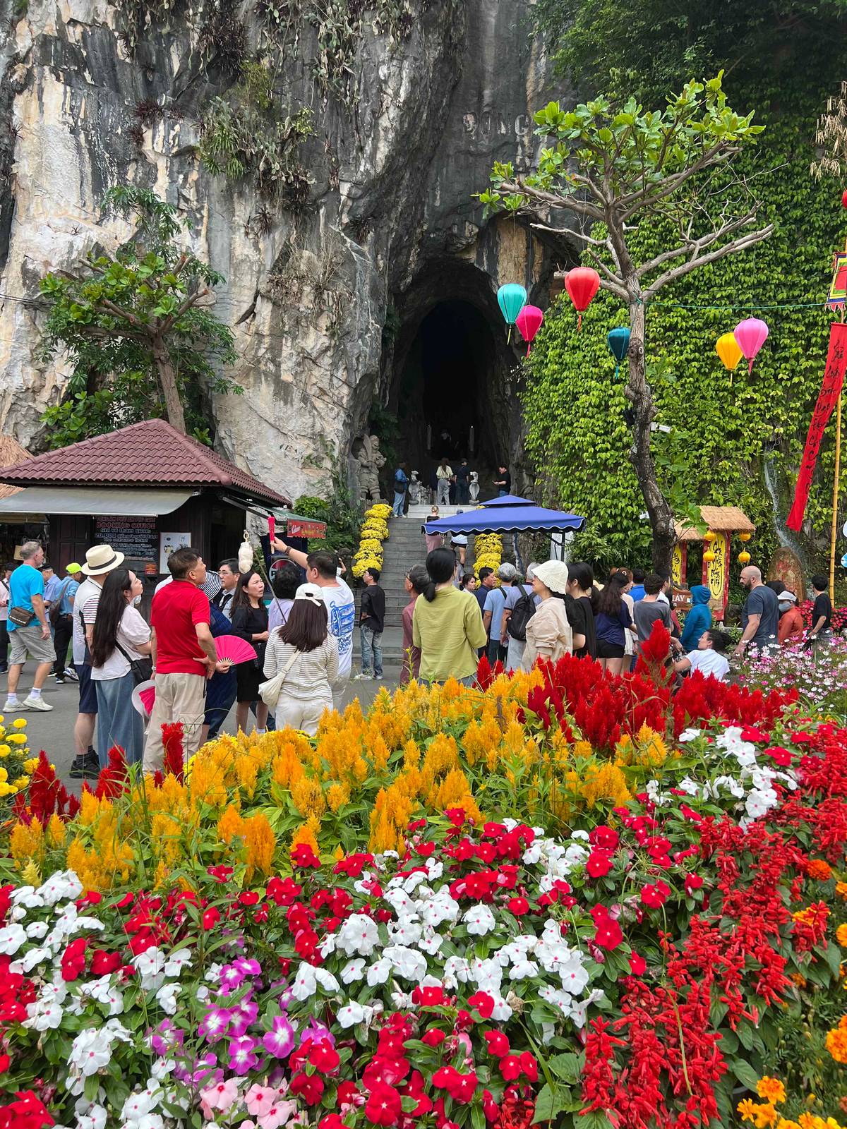 AN entrance to one of the caves in the Marble Mountains, filled with blooms.