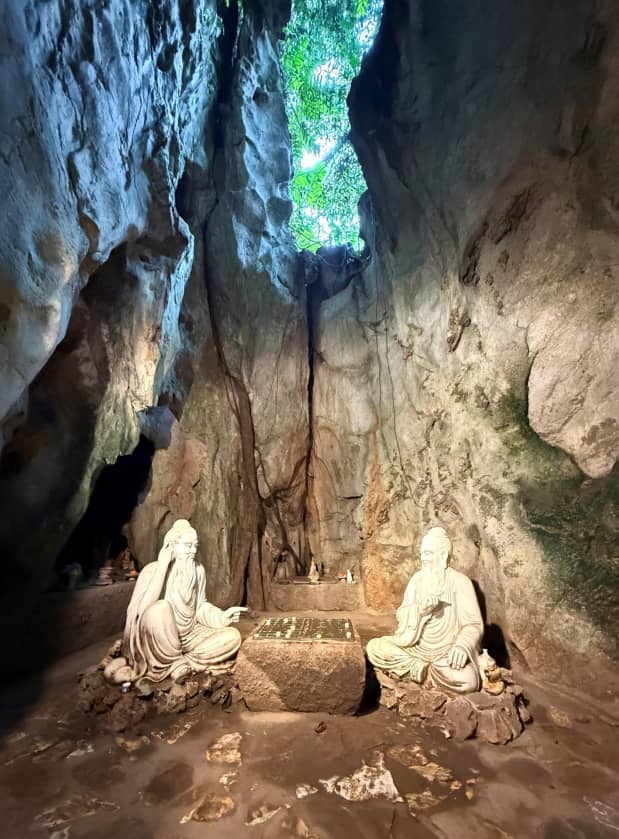 LIGHT shines upon the statues of two wise men engaged in a board game.