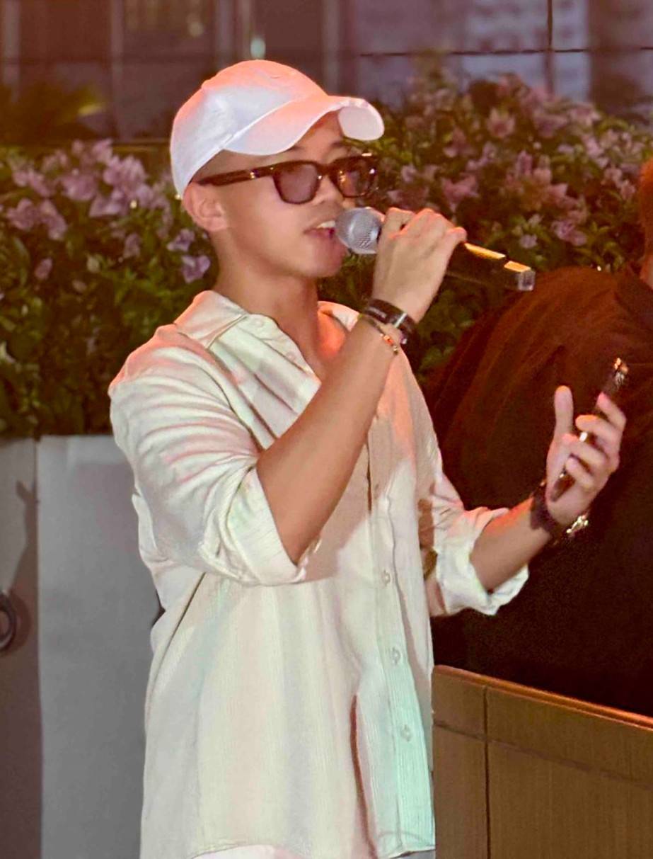 XANDRIX Corpuz Jr., founder and CEO of TLI Radio, delivers his speech during the Summer 009 sunset event at Solaire North, highlighting the community-driven spirit behind the sober-curious gathering.