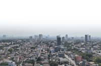 HAZE lingers over Metro Manila as smoke continues to billow from the contained fire at the closed Navotas City Sanitary Landfill, prompting the Environmental Management Bureau-National Capital Region to urge residents to remain cautious and wear masks against potentially harmful air pollutants.