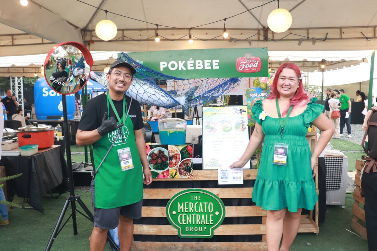 The Grand Prize Winner of NBFE 2026, Goldwin Garcia and Vina Garcia, the owners of PokéBee, pose for a photo in front of their stall during the live sell-off held on April 18, 2026