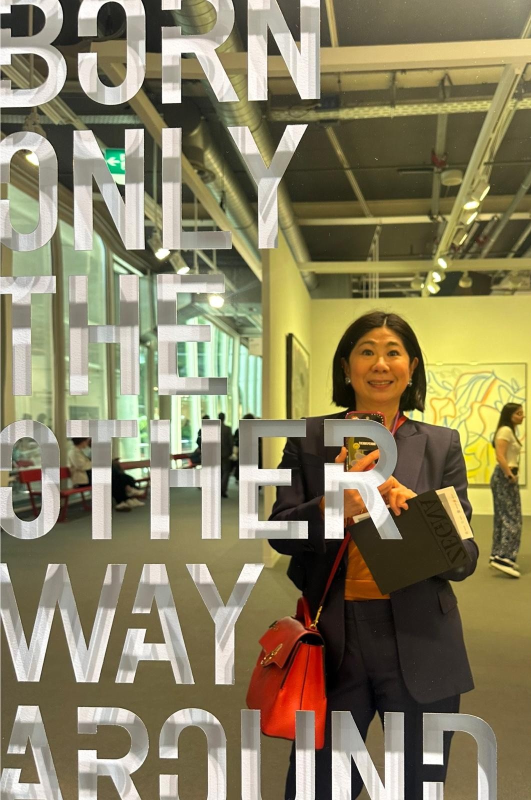 SELFIE with artwork of Rirkrit Tiravanija ‘Born the Other Way Around’ at Art Basel in Basel Switzerland 2024.