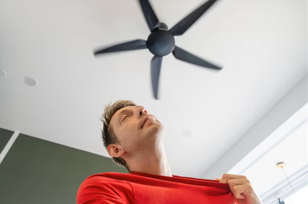 A CEILINGfan spins steadily in a living room, circulating air to ease the heat during a humid summer afternoon.