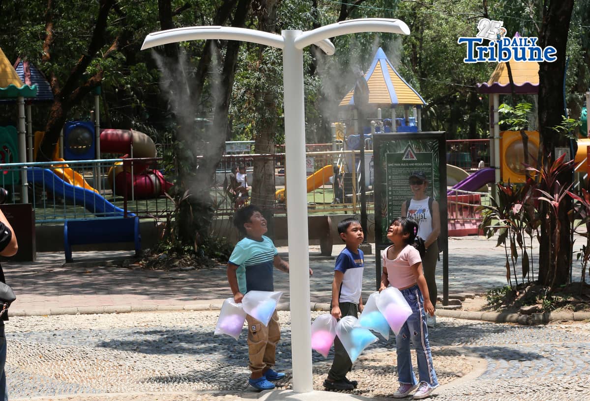(April 22 2026) Families enjoy the newly installed outdoor misting system at the Quezon Memorial Circle in Quezon City on Wednesday, April 22, 2026. The misting areas, located within the park, offer instant cooling for visitors, joggers, and diners as part of city efforts to improve park comfort, to provide relief from intense summer heat. Photo/Analy Labor