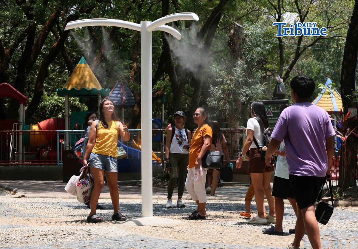 (April 22 2026) Families enjoy the newly installed outdoor misting system at the Quezon Memorial Circle in Quezon City on Wednesday, April 22, 2026. The misting areas, located within the park, offer instant cooling for visitors, joggers, and diners as part of city efforts to improve park comfort, to provide relief from intense summer heat. Photo/Analy Labor