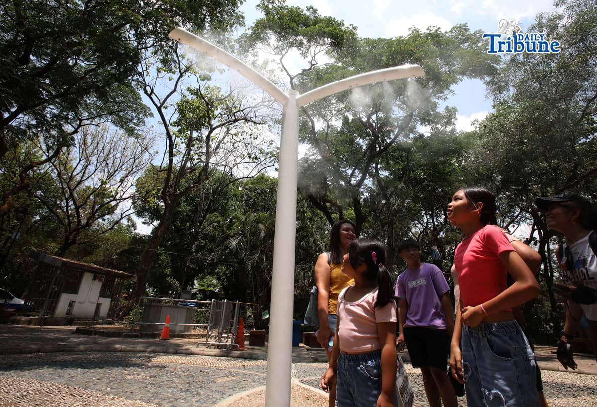 (April 22 2026) Families enjoy the newly installed outdoor misting system at the Quezon Memorial Circle in Quezon City on Wednesday, April 22, 2026. The misting areas, located within the park, offer instant cooling for visitors, joggers, and diners as part of city efforts to improve park comfort, to provide relief from intense summer heat. Photo/Analy Labor