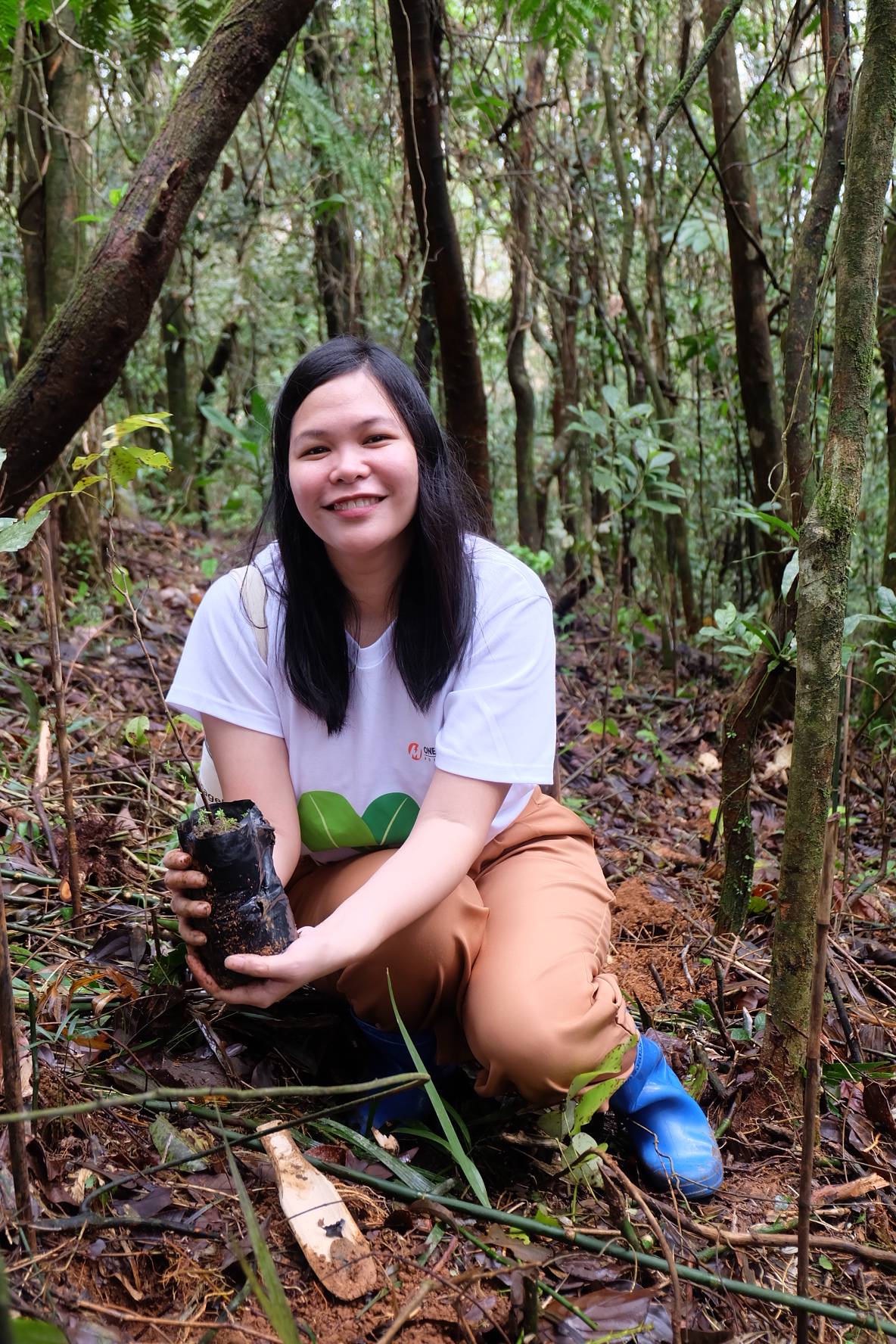 SINILOAN, Laguna. Meralco employee like Raizza David joins reforestation efforts to make the Sierra Madre mountains stronger against powerful storms.