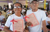 TWO ARBs proudly display their CLOAs during the awarding of land certificates in Floridablanca, Pampanga on 23 April, led by the provincial government.