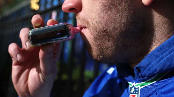NEW YORK, NEW YORK - DECEMBER 02: A person uses a vape pen near Bryant Park on December 02, 2024 in New York City. The Supreme Court began to hear arguments on the Food and Drug Administration, refusal to approve flavored e-cigarettes over public health concerns.