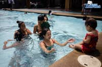 Tondo residents take advantage of the free swimming pool program amid extreme heat