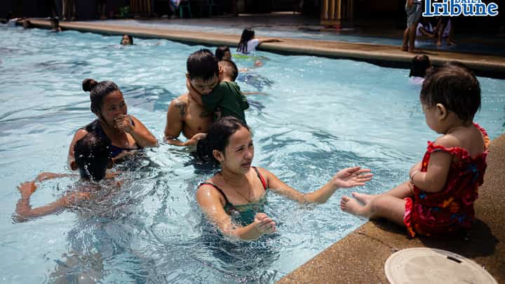 Tondo residents take advantage of the free swimming pool program amid extreme heat