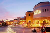 EVIA transforms at night with warm lights reflecting across the lagoon, creating a cozy and romantic atmosphere.