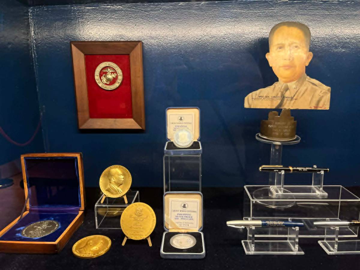 MEDALS, commemorative coins and personal pens on display, reflecting the honors and milestones in Carlos P. Romulo’s distinguished career.