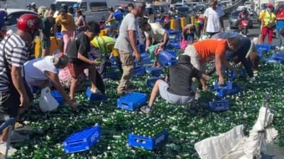 Overloaded soda truck overturns at C5