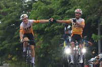 Yousef Ibraheim Alrefai and Nikita Shulchenko of LCW UAE Cycling Team celebrate after crossing the finish line at the Praying Hands Monument in Tagaytay City during the opening lap of the MPTC Tour of Luzon on Wednesday.