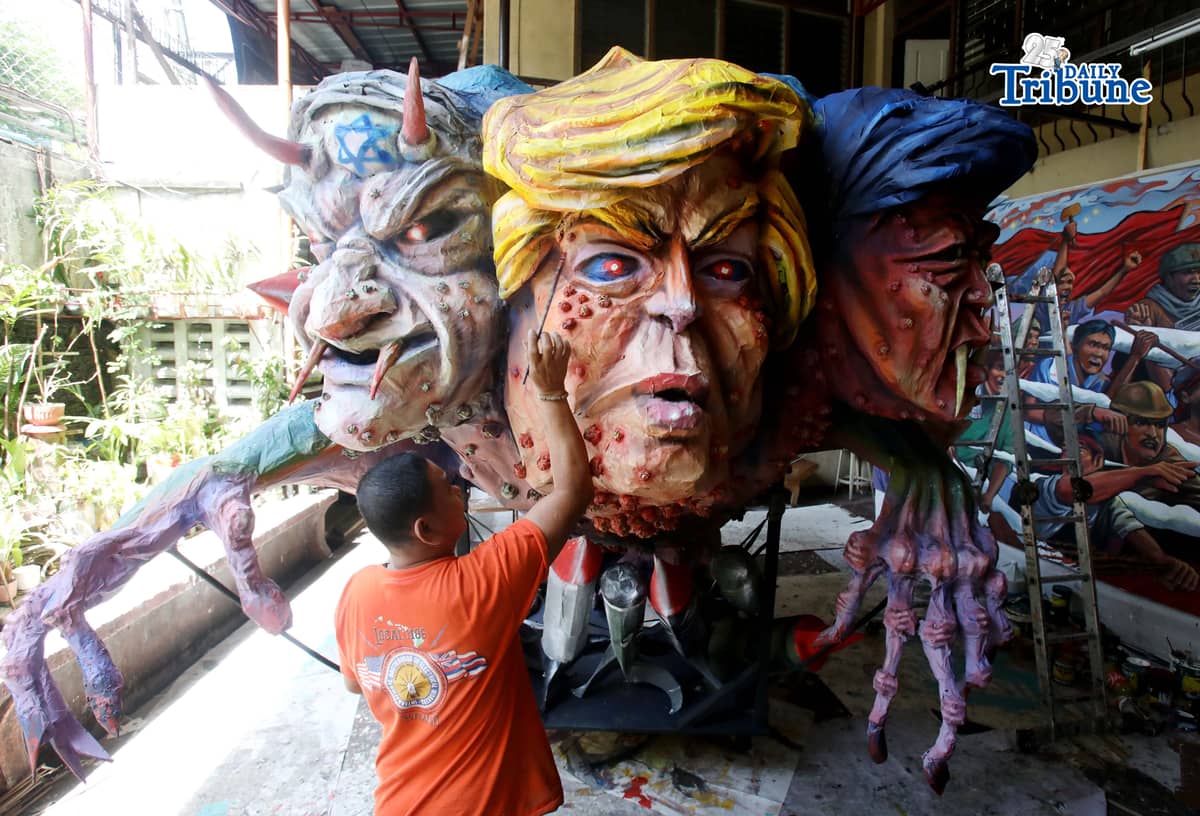 (April 30 2026) On Thursday April 30 2026 in Quezon City ahead of Labor Day, an Artists apply finishing touches at the effigy named “Trio Delubyo” for Labor Day protest on May 1 2026, The effigy featuring US President Donald Trump, Israel Prime Minister Benjamin Netanyahu and President Ferdinand Marcos Jr. , fused into a lizard-like entity signifies decaying state of imperialism and its “attempts” to maintain global dominance while rockets embedded in its body depicts the United States’ continued war amid its waning influence in West Asia. Photo/Analy Labor