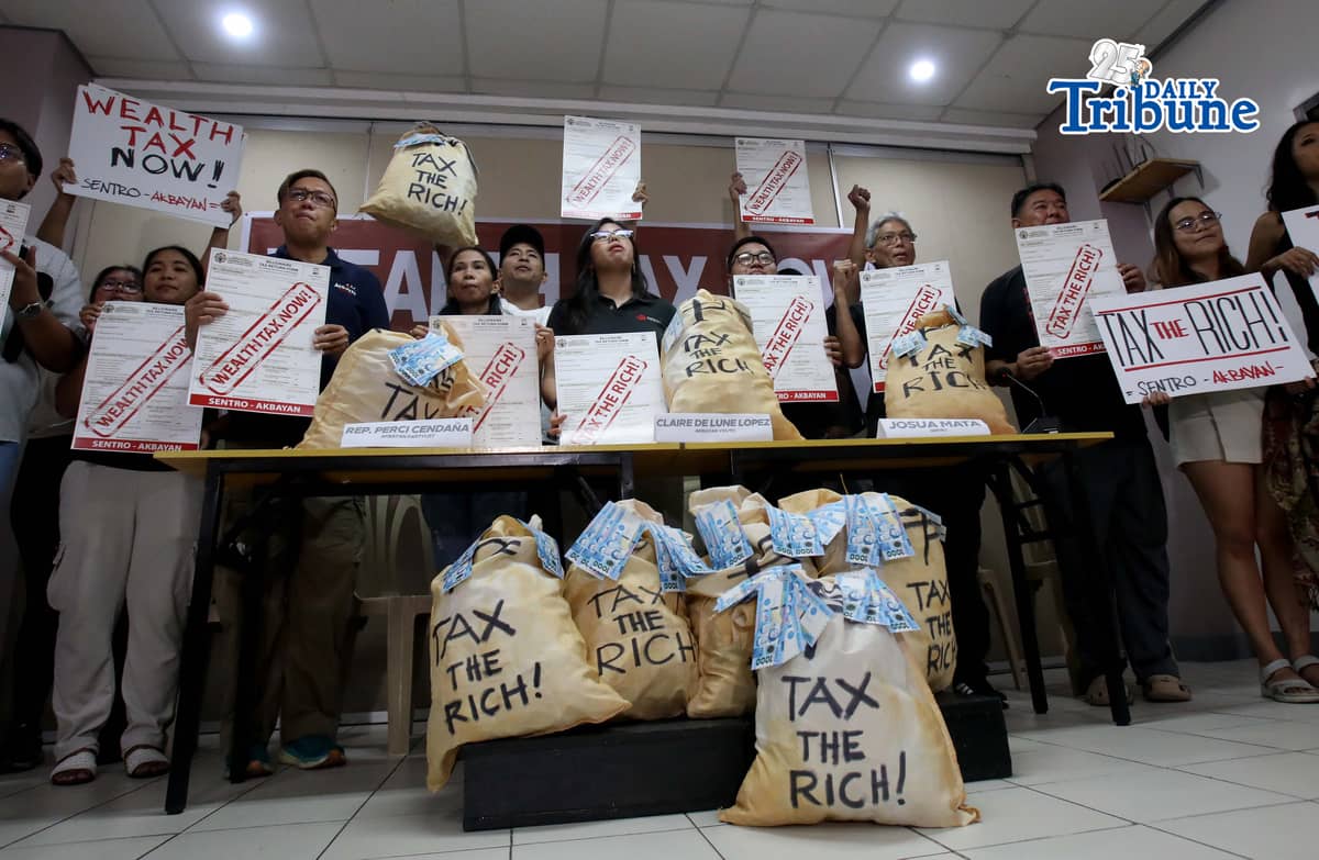 (April 30 2026) Ahead of Labor Day public and private sector workers, alongside the Akbayan Partylist and allied youth, hold a placard and a bundle of play money during the press conference on Thursday April 30 2026, as they called for the legislation and enforcement of wealth tax in conjunction with calls from other groups for a decrease in ordinary worker’s taxes. Photo/Analy Labor