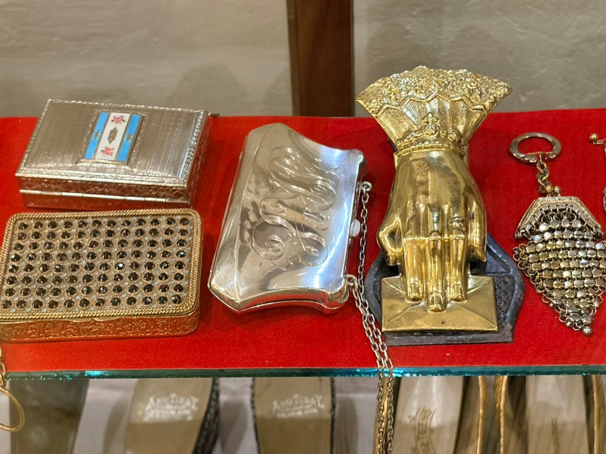 Metal clutch bags serve as ornate accessories that complete elegant evening wear.