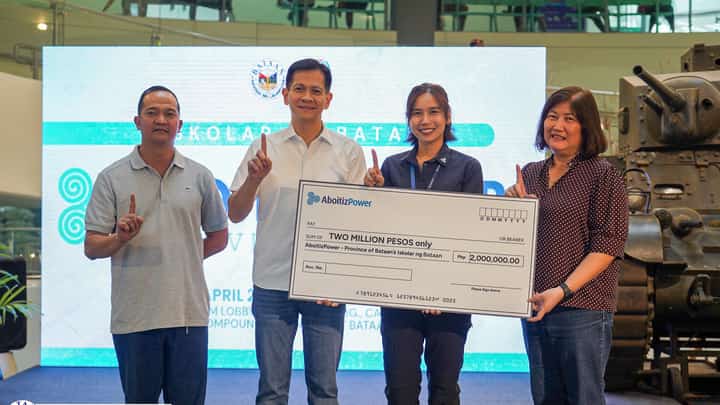 Governor Joet Garcia and Vice Governor Cris Garcia receive the ceremonial check from AboitizPower Vice President for Corporate Services Andrea Madrid, with Iskolar ng Bataan coordinator Ramon Cañas witnessing the turnover.