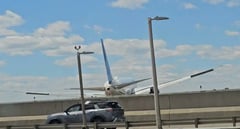 Jet clips lamppost, truck while landing