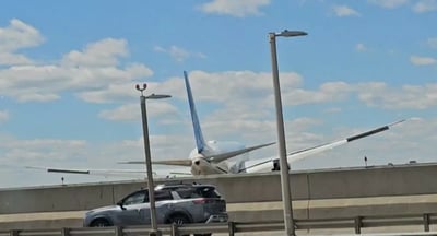 Jet clips lamppost, truck while landing