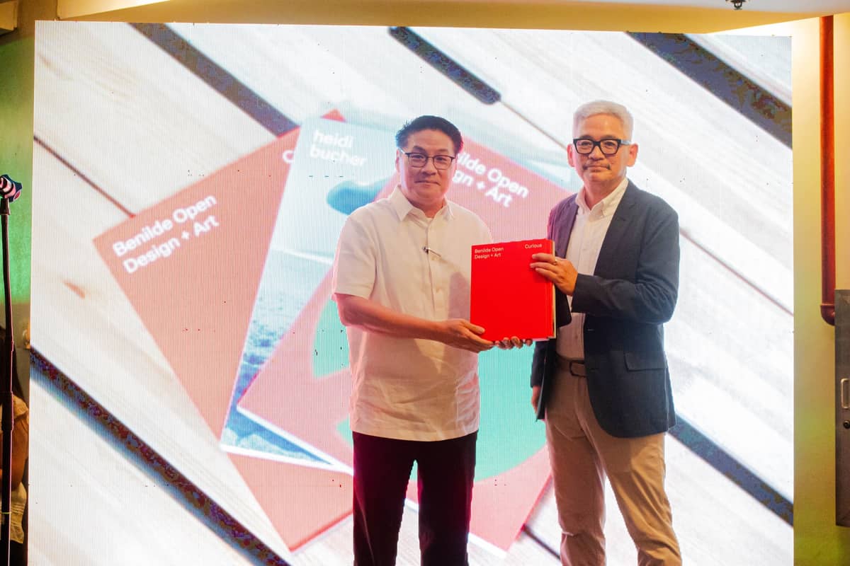 DR. David Bayot, Director of DLSU Publishing House presents a book of a compilation of the works from the first edition of Benilde Open Design + Art to Br. Dodo Fernandez FSC, president and convenor.