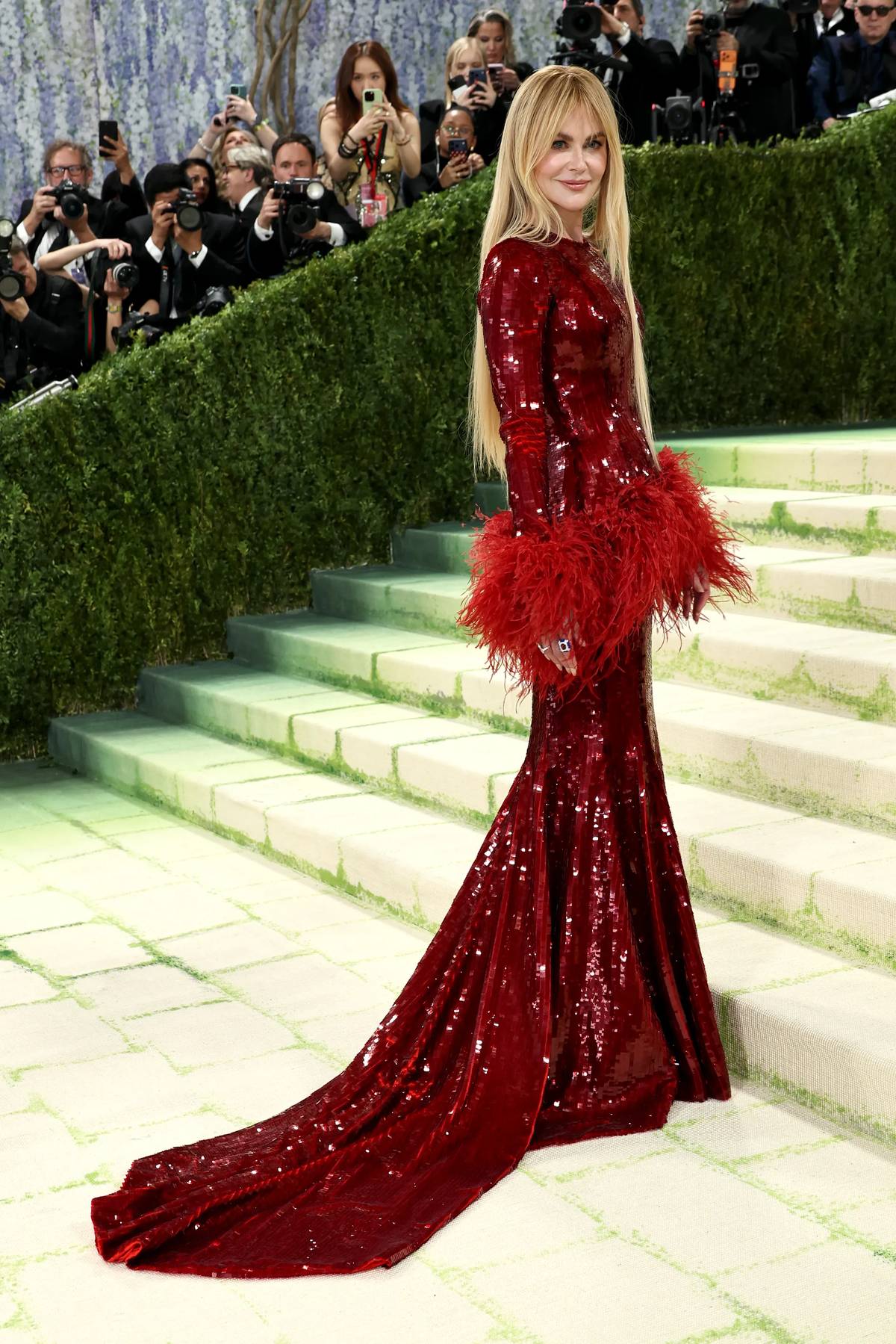 MET Gala 2026 co-chair Nicole Kidman looked stunning in scarlet Chanel with feathered cuffs and a long train.