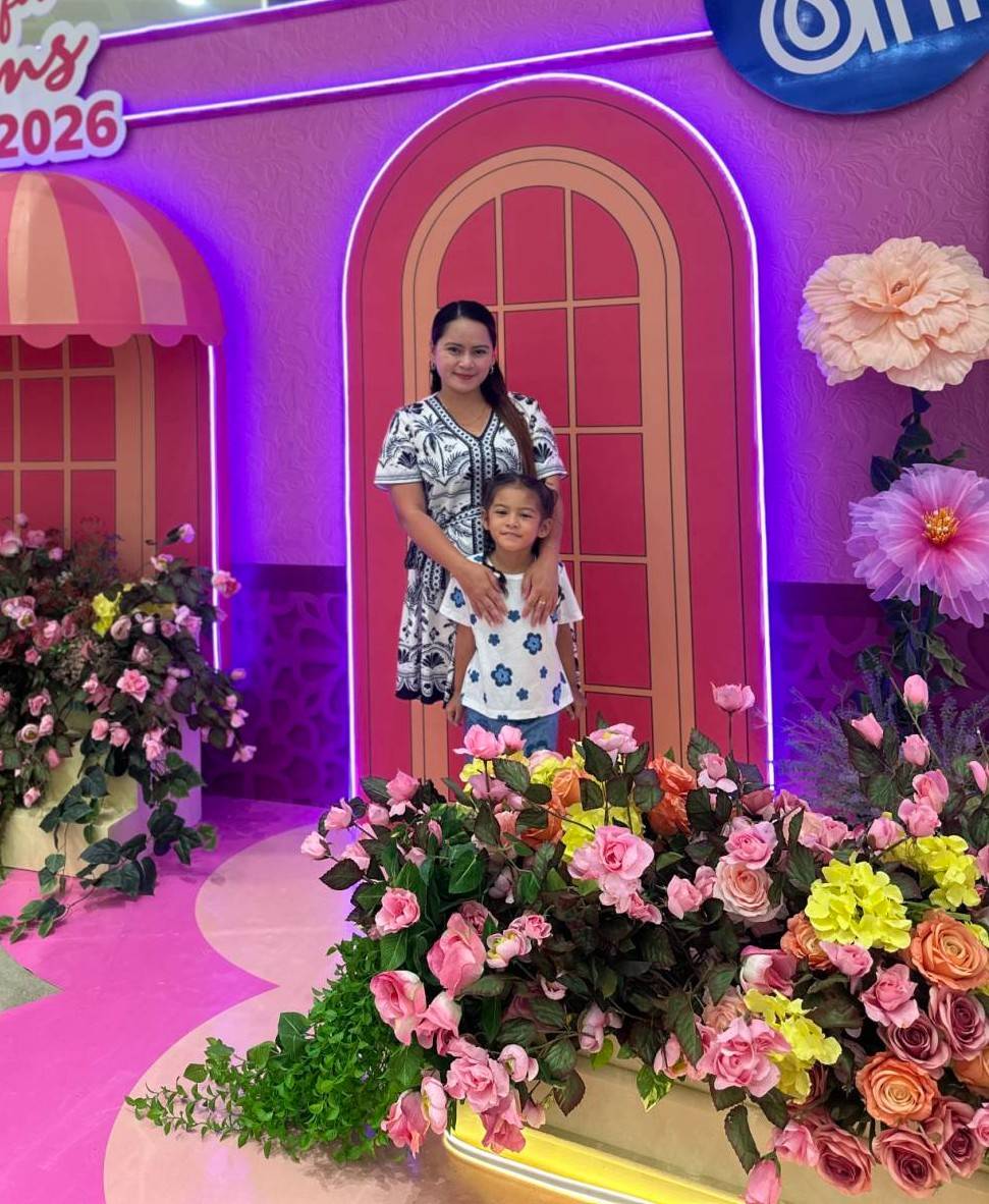 A MOTHER and daughter pose at a floral Mother’s Day display at SM City Davao.