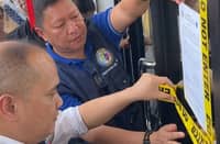 PERSONNEL from the Department of Migrant Workers padlock an unlicensed agency in Manila on Monday. The firm was shut down for allegedly defrauding aspiring overseas Filipino workers with false promises of high-paying jobs abroad.
