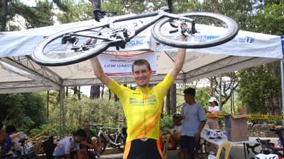 NIKITA Shulchenko lifts his bike for a triumphant celebration after ruling the MPTC Tour of Luzon on Wednesday at Camp John Hay in Baguio City.