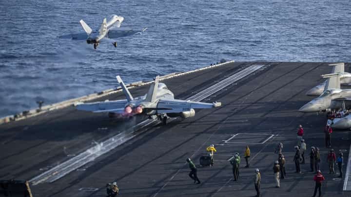 AN F/A-18E Super Hornet and an EA-18G Growler launch from the flight deck of aircraft carrier USS Abraham Lincoln on 9 May 2026.