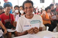 RESIDENTS near Mayon Volcano in Albay province are all smiles as they receive the cash assistance provided by the Department of Social Welfare and Development.