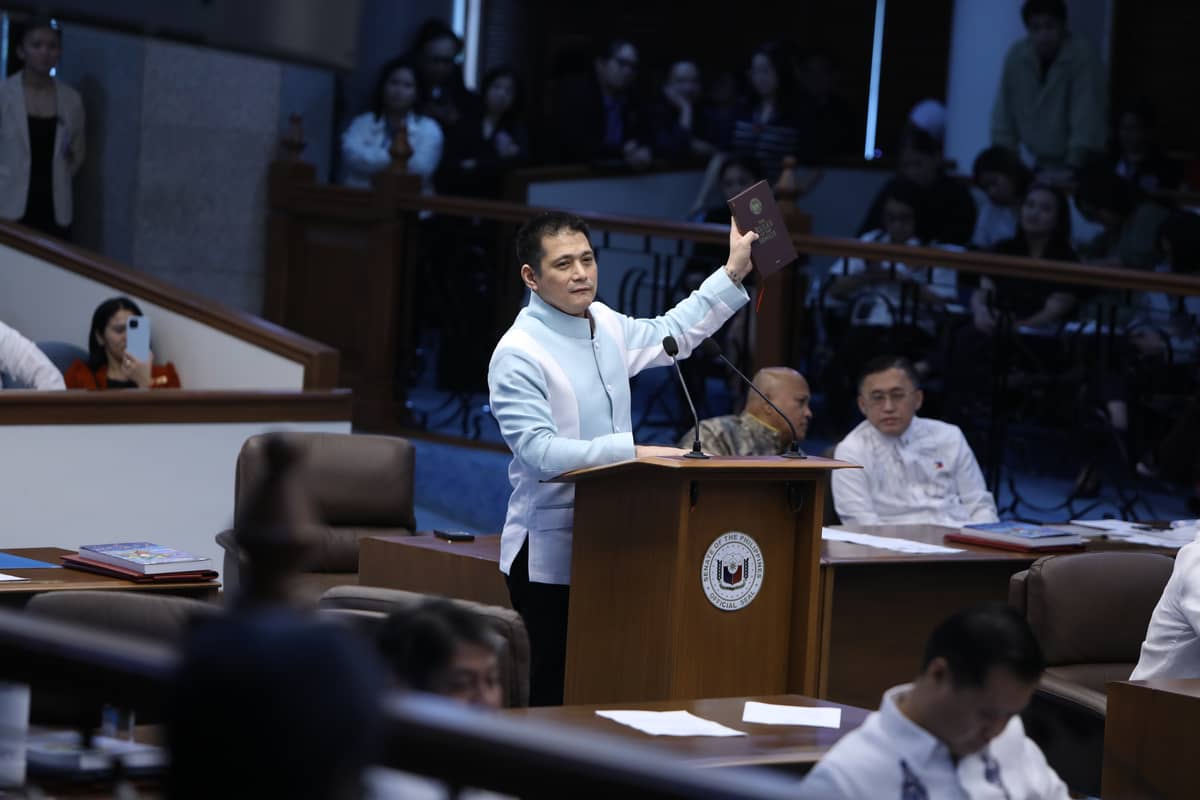 Senator Robinhood Padilla raises the “Rules of Senate” book emphasizing frustration against Senator Kiko Pangilinan’s action over a heated debate the day before.