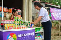 A DIGIPLUS Foundation volunteer assists a community member during a local outreach activity, as BingoPlus users can now track the foundation’s projects and social causes directly through the BingoPlus app.