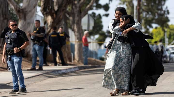 TWO women react as they leave a reunification center following the shooting at the Islamic Center of San Diego in southern California. A shooting at the largest mosque complex in San Diego killed three people, with two suspected teenage gunmen later found dead in a car from self-inflicted gunshot wounds, police said.