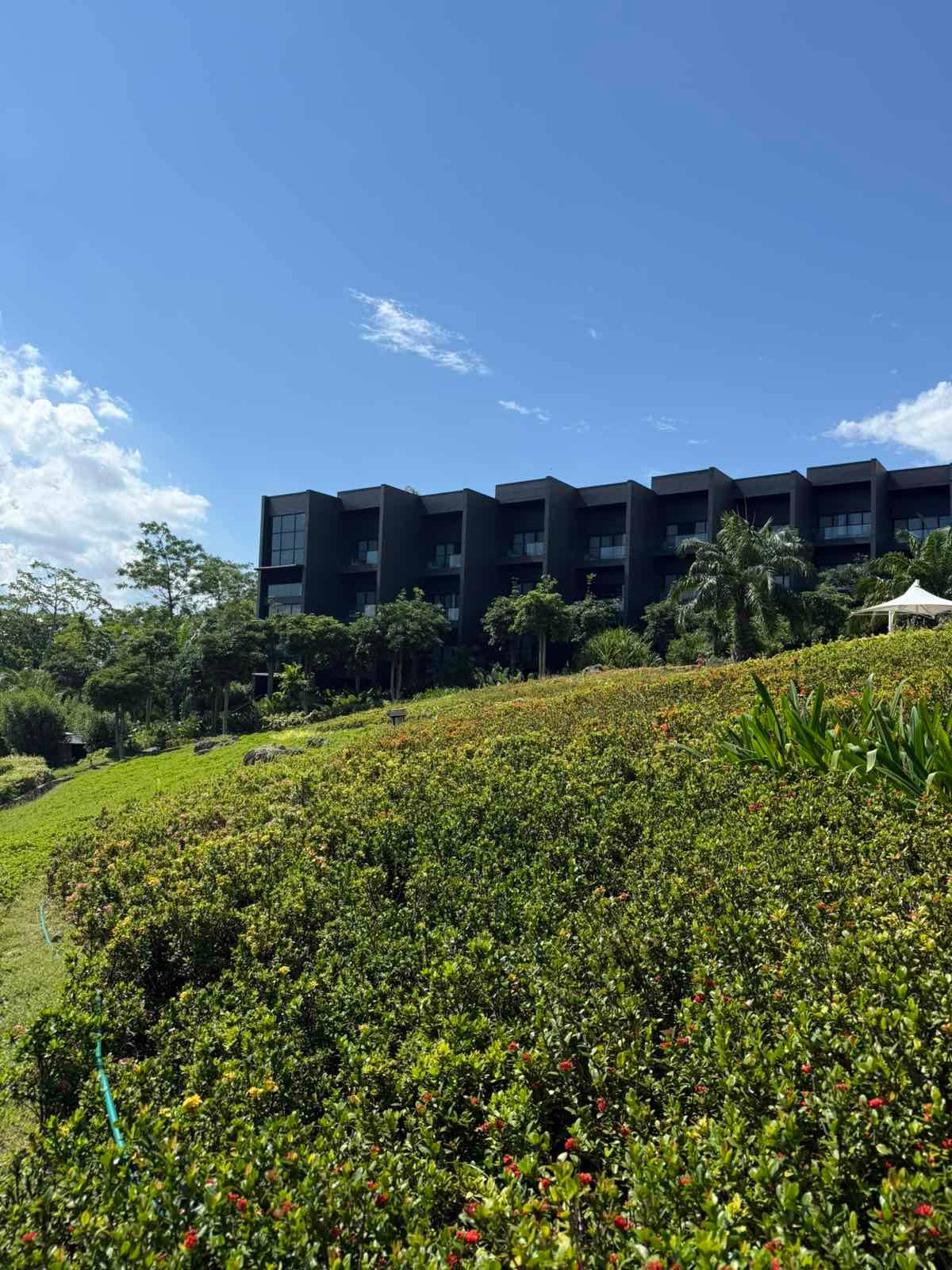 DISCOVERY Samal’s striking black brutalist architecture rises quietly behind lush greenery, proving modern luxury does not have to overpower nature to stand out.