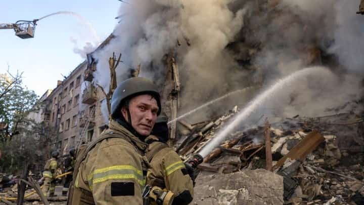 FIREFIGHTERS work to extinguish a fire at the site of a heavily damaged building following Russian strikes to the Ukrainian capital in Kyiv on 24 May 2026, amid the Russian invasion of Ukraine.