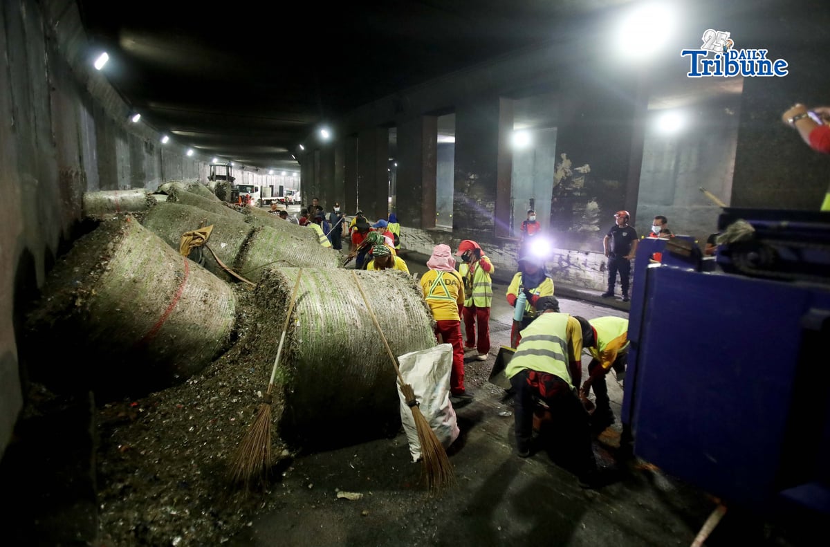 (May 27 2026) The Metropolitan Manila Development Authority (MMDA) street sweepers remove the trash scattered, after a trailer truck loaded with garbage overturned in the southbound lane of the C5-Bonny Serrano Tunnel in Quezon City early Wednesday, May 27, 2026. The incident, which occurred around 5:00 a.m., resulted in the driver and his wife being injured. According to the report, the truck came from Porac, Pampanga, and was heading to Batangas when the vehicle lost control after skidding. Photo/Analy Labor